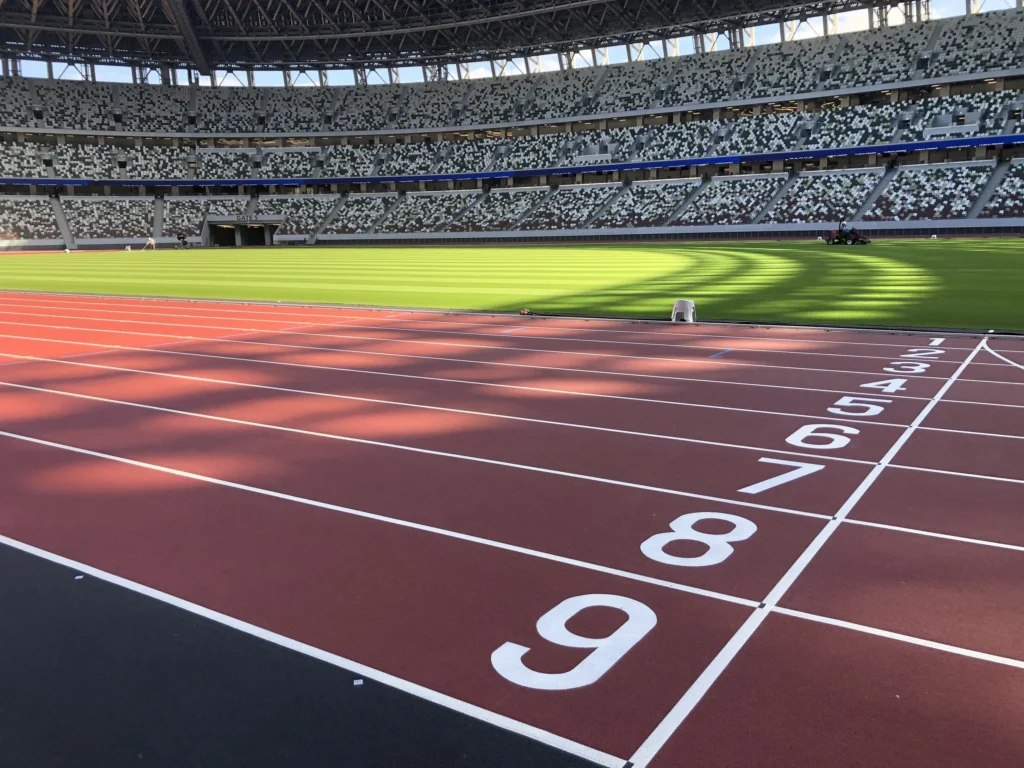 Lane markings on a red synthetic athletics track in a stadium