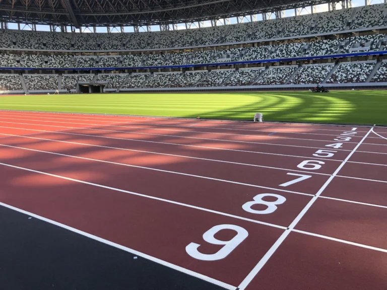 Lane markings on a red synthetic athletics track in a stadium