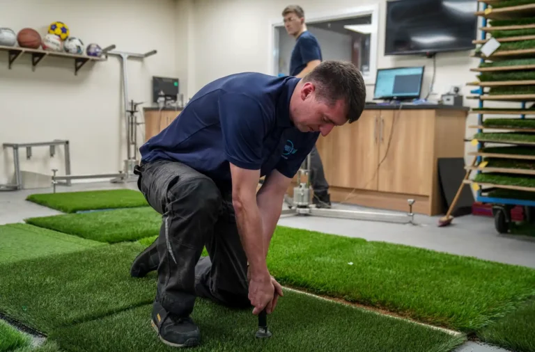 Sports Labs technician examining a synthetic turf sample in the laboratory