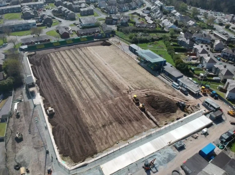 Aerial view of a sports pitch under construction, stripped back to the sub base