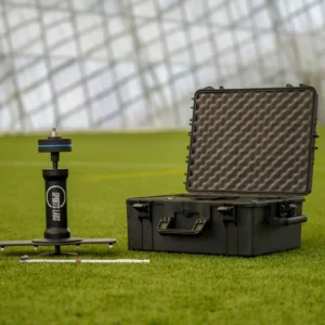 Prism Gauge set up on artificial grass next to its open protective carry case